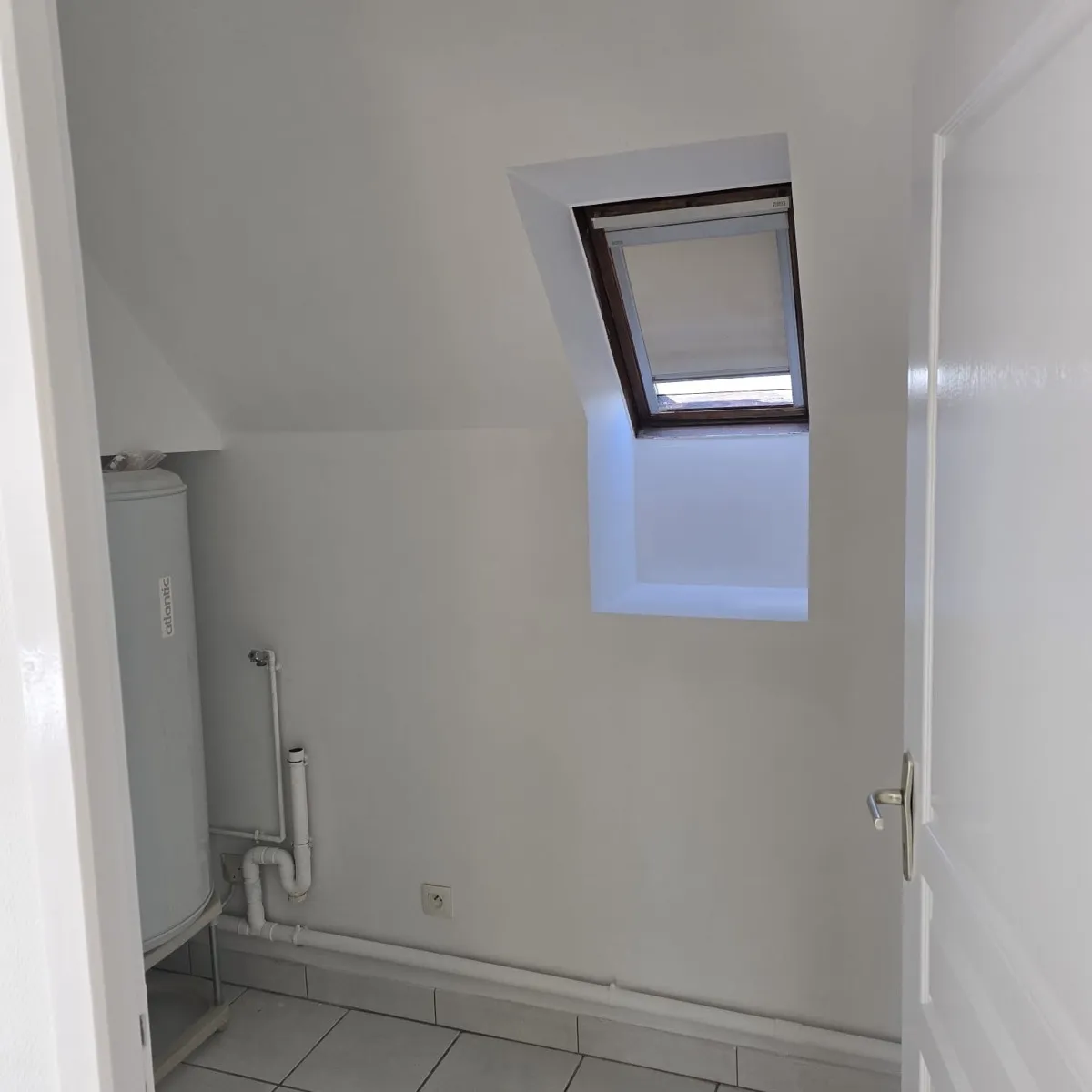 Buanderie sous combles repeinte en blanc dans un appartement à Blois